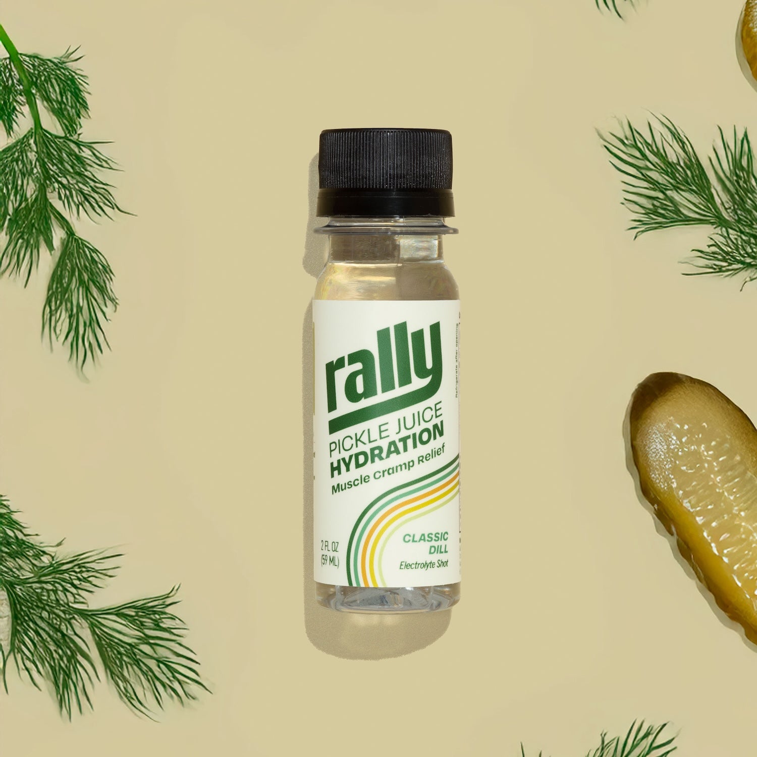 A Rally pickle juice hydration shot bottle on a tan background with fresh dill and pickle slices — the new 2 oz competitor to Fast Pickle